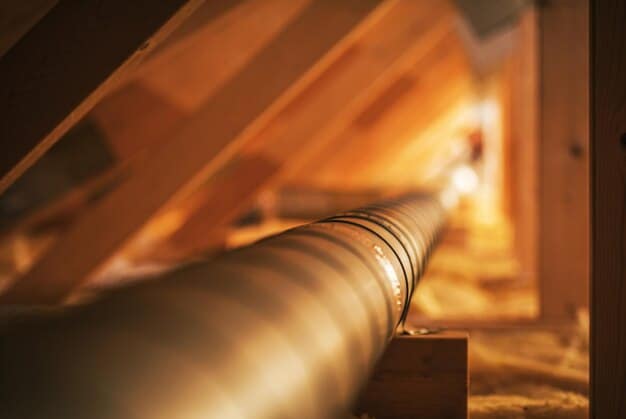 An image showcasing the installation of new insulation in an attic, with a focus on areas around pipes and vents being properly sealed for energy efficiency.