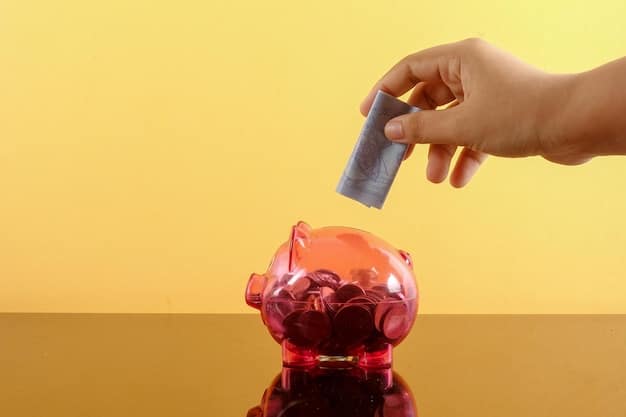 A close-up shot of a hand placing coins into a piggy bank, symbolizing savings. The piggy bank is colorful and modern, placed on a wooden surface, with the background slightly blurred to focus on the action of saving.