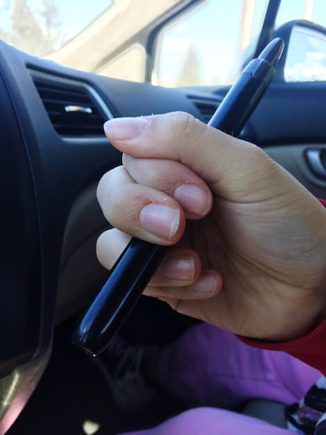 A hand holding a pen and writing down mileage in a logbook, with a car dashboard visible in the background, symbolizing accurate mileage tracking for tax deduction purposes.