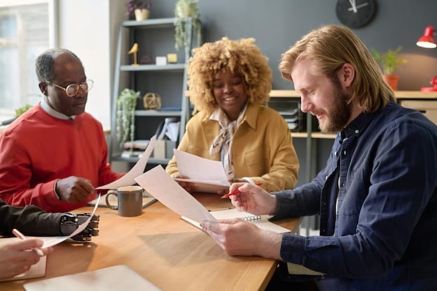 A diverse group of people reviewing financial documents together at a table, symbolizing collaboration and understanding of credit reporting and financial rights.