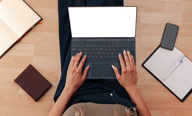 A bird's-eye view of a person's hands typing on a laptop keyboard, with a notebook and pen beside it. The laptop screen displays a spreadsheet with cryptocurrency transaction data, and the overall setting suggests a focus on meticulous record-keeping for tax purposes.