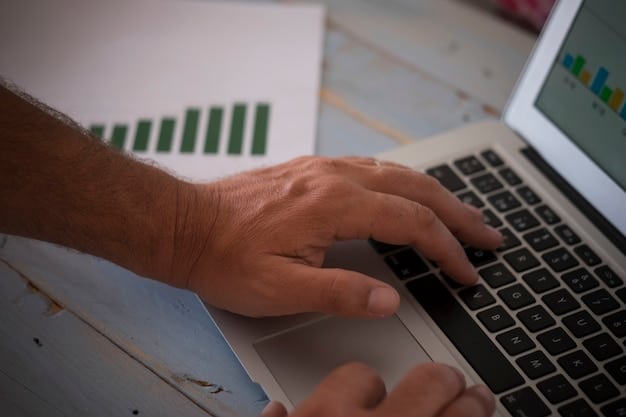 A close-up of a person's hand entering data into a spreadsheet on a laptop. The spreadsheet should show columns for different expense categories, such as 
