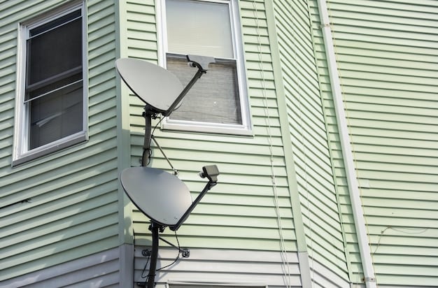 An indoor HDTV antenna placed near a window, connected to a television. The TV displays a clear over-the-air broadcast channel.