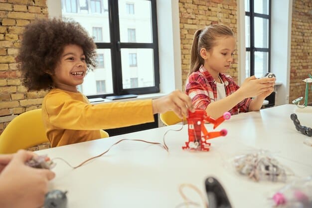 A group of excited children participating in a hands-on science experiment, possibly building a robot or conducting a chemistry demonstration, highlighting early STEM engagement.