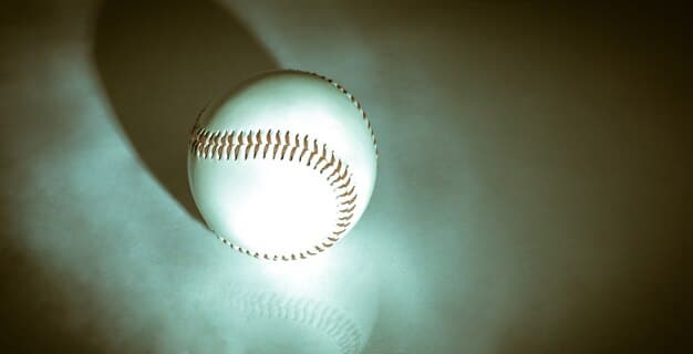 A close-up of a baseball bat hitting a ball, with blurred stadium lights in the background, symbolizing powerful hitting and offensive impact.