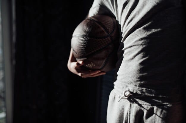 A close-up, intense shot of a young basketball recruit during a free throw, showing focused determination and sweat, with a muted, blurred court background, highlighting concentration.