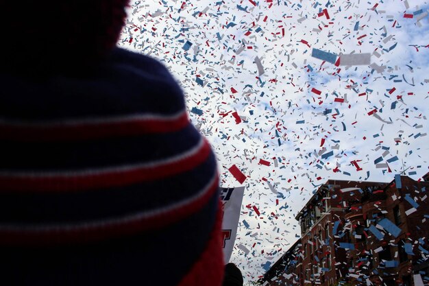 A close-up of an NHL Stanley Cup with confetti falling, symbolizing the aspiration of buying teams at the trade deadline. The lighting is dramatic and celebratory.