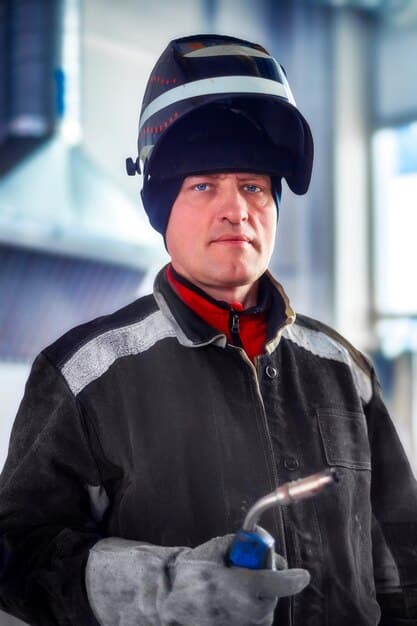 A detailed image of a pit crew member wearing advanced protective gear, including a helmet, fire-resistant suit, and gloves, emphasizing safety innovation in motorsports.