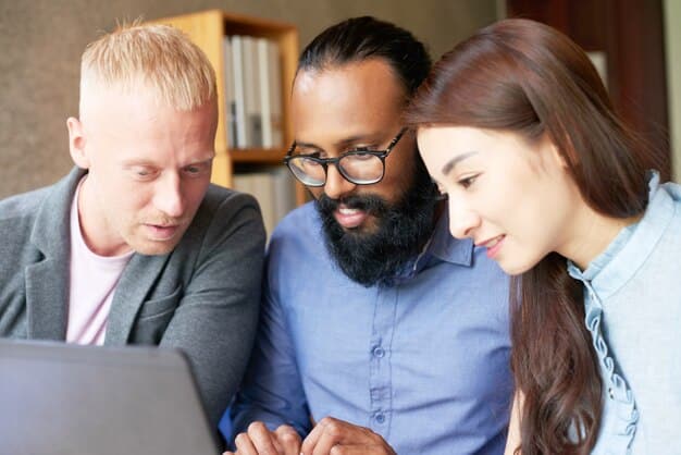 A close-up of a diverse team of engineers and developers collaborating around a large digital display showing lines of code and data visualizations, symbolizing the intersection of human expertise and advanced technology in driving innovation.