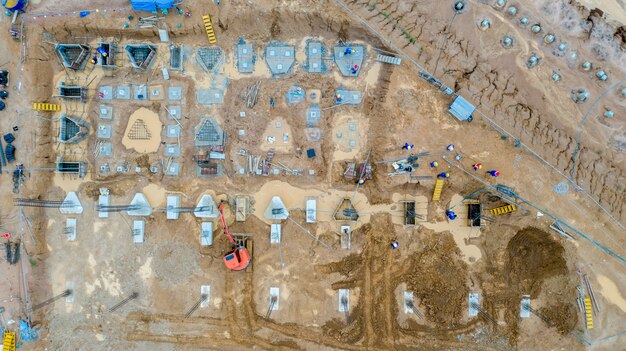 An aerial view of a massive construction site, with cranes and heavy machinery indicating the development of a large, state-of-the-art semiconductor fabrication plant under construction in Arizona or Ohio, symbolizing US investment in domestic chip manufacturing.