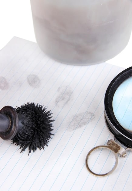 A magnifying glass hovering over a newspaper headline, with several pens and notebooks scattered around, symbolizing research and verification.