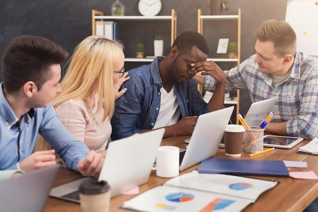 A diverse group of students looking stressed while gathered around a table with financial aid forms and a laptop displaying a budget, symbolizing the challenges of college financing.