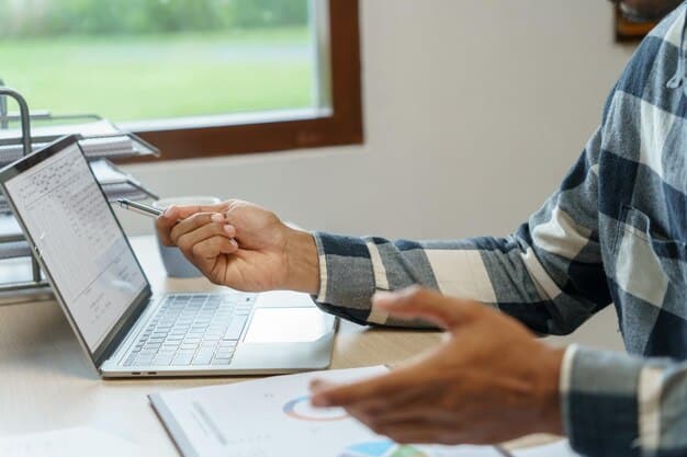 A person's hands filling out an online application form on a laptop, with financial aid documents spread out on a desk, illustrating the application process for college.