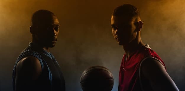 A split screen showcasing two star players facing off during an NBA Finals game. The image captures the intensity and rivalry between them, highlighting the power of star matchups to draw in viewers and contribute to NBA Finals Ratings Surge 15%: Analyzing the Impact of Star Power.