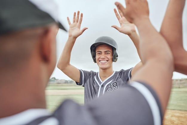 A young baseball player is stretching before practice with a coach. He is smiling, but his muscles seem tense, illustrating the importance of proper training and flexibility. The background shows a well-maintained baseball field and equipment. Youth Sports Specialization: Is It Hurting Young Athletes?.