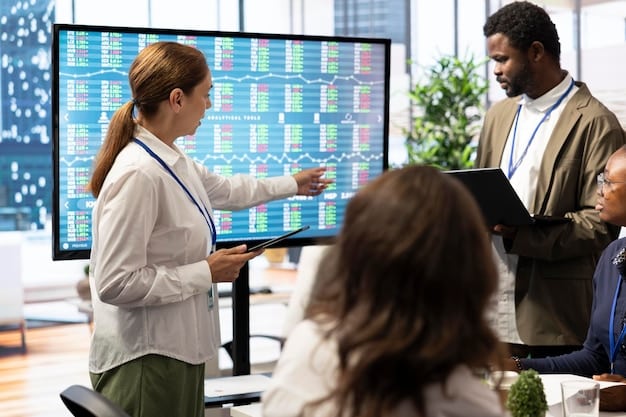 A diverse group of business professionals in a modern office looking at graphs and cybersecurity dashboards, indicating collaborative problem-solving and proactive defense strategies.