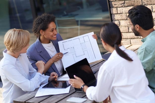 A diverse group of business professionals discussing blueprints for a sustainable building, with charts and graphs on a board in the background, illustrating financial projections.