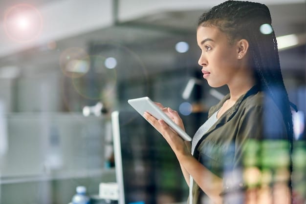 A retail associate using a tablet to check inventory and assist a customer, demonstrating modern in-store technology.