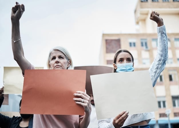 People protesting in front of a government building holding signs advocating for human rights. The signs include a variety of slogans related to human rights and social justice. Captures the US Role in International Human Rights: Examining the Country's Efforts to Promote and Protect Human Rights Worldwide through activism.